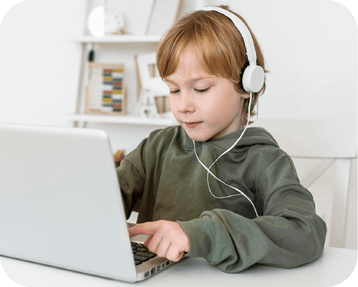 young boy using laptop with headphones 1 1